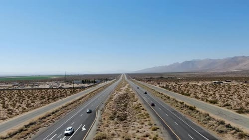Aerial View of Road in the Middle of the Desert Under Blue Sky in California Desert