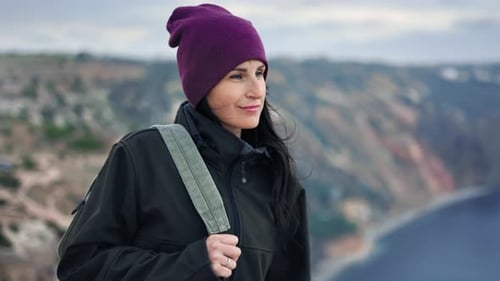 Backpacker Female Walking on Mountain Peak Admiring Dramatic Sky Scenery Enjoying Trekking Outdoor