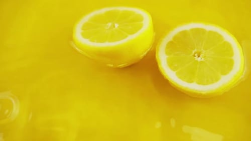 Bright Lemon Halves Floating in Yellow Juice