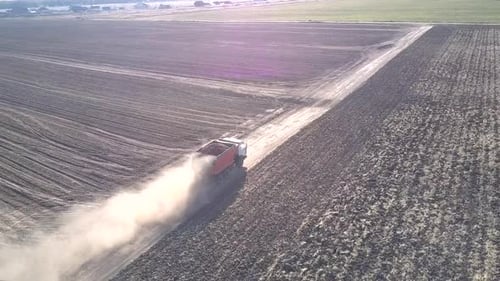 Drone Flies Over Truck with Potatoes Raising Dust Clouds
