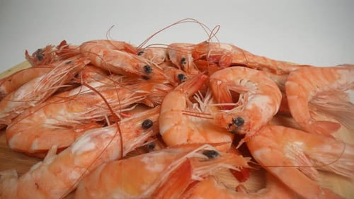 Cooked Shrimp Pile on Wooden Cutting Board