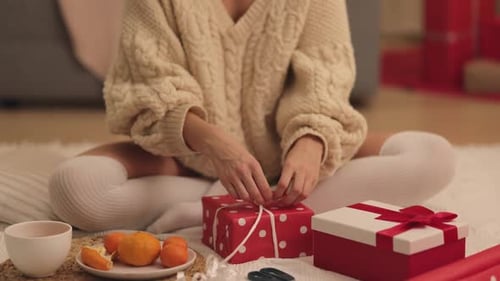 Woman Wrapping Christmas Gifts at Home