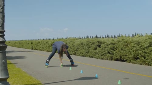 Woman Roller Skating and Practicing Skills with Cones
