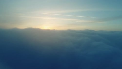 Aerial Shot of Golden Light Streaming Through Clouds