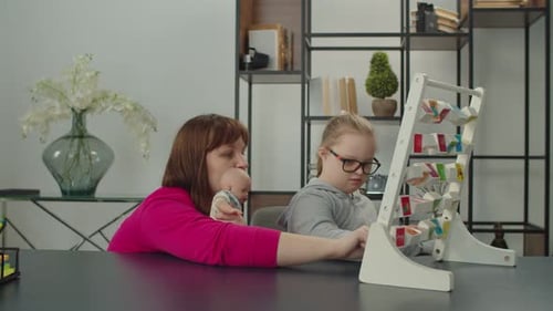 Woman and Child Playing with Blocks Indoors