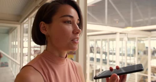 Businesswoman talking on mobile phone in a modern office 4k