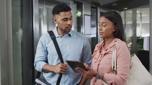 Colleagues Discussing Information on a Tablet Device