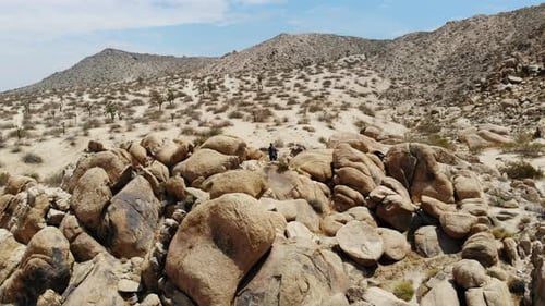 Desert Landscape with Rocky Outcrops and Distant Mountains