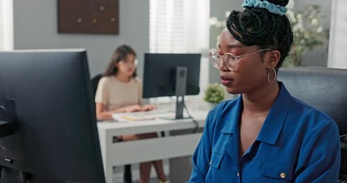 Woman Working at Computer in Modern Office