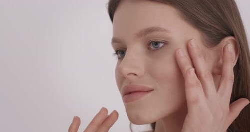 Attractive Woman Massaging Face in Close Up