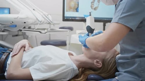Dentist Scanning Woman's Teeth with Modern Technology