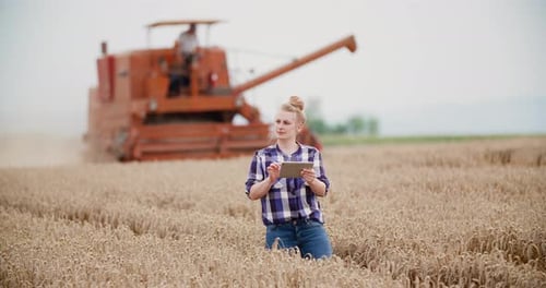 Agriculture Female Farmer Walking in Wheat Field with Digital Tablet