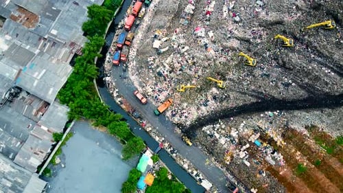 Aerial View. Large landfills like mountains. the tractor take garbage on landfills