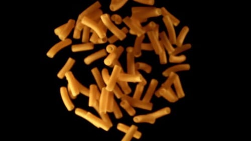 Rigatoni Pasta Falling in Slow Motion on Black