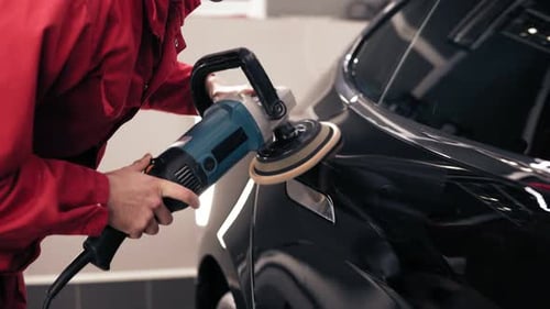 Car Detailer Buffing Black Vehicle