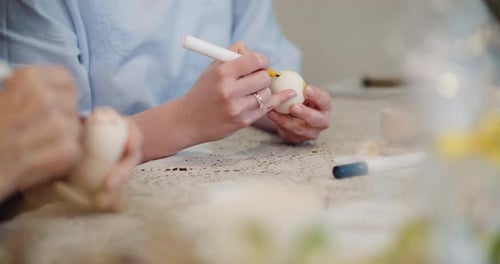 Happy Easter - Close Up of Grandfather and Granddaughter Hands Coloring Easter Eggs.
