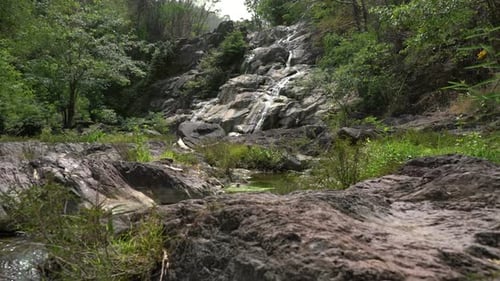 Rocky Waterfall Cascades in Lush Green Nature