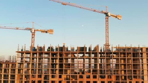 Aerial Shot of the Building in the Process of Construction. Labor Working in Big Construction Site