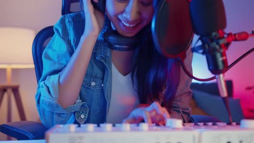 Woman Singing and Playing Keyboard in Home Studio