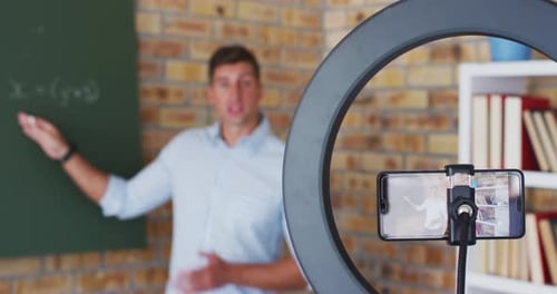 Teacher Explaining Math Equation in a Classroom