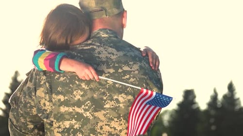 Soldier and Girl Embrace, Holding American Flag