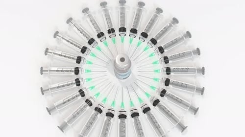 Medical Syringes and Vaccine Vial Appearing in Circle
