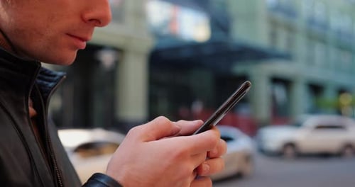 Close Up Man Using Smartphone in a City