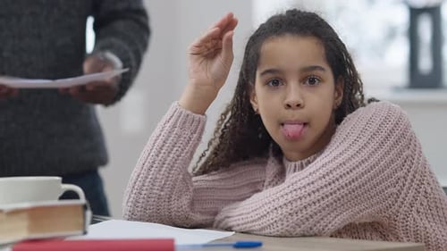 Misbehaving African American Adolescent Girl Grimacing Saying Blabla As Unrecognizable Man Gesturing