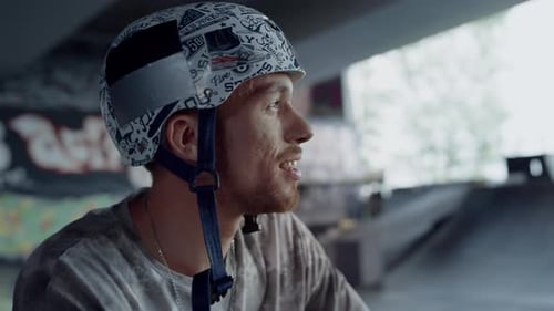 Smiling Teen Looking Training at Skatepark