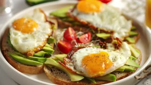 Close Up of Healthy Breakfast with Sliced Avocado Sandwiches with Fried Egg