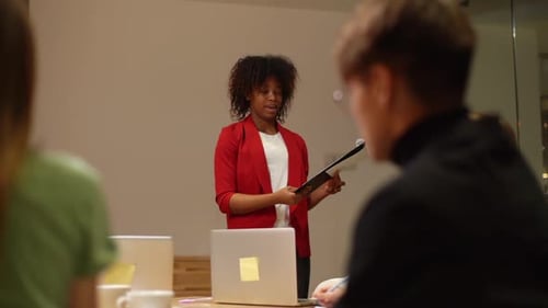 View From Back Colleagues of Creative Business Team in Meeting Room Listening to Female
