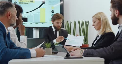 Business Meeting with Diverse Professionals Reviewing Data