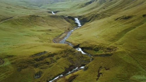 Beautiful Aerial Drone View of Icelandic Landscape with Green Fields and River in Summertime