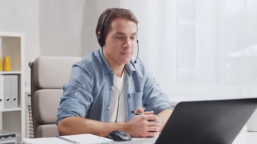Workplace of freelance worker at home office. Young man works using computer.