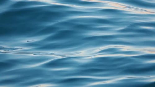 Close Up of Disturbed Blue Ocean Water Surface. Slow Motion