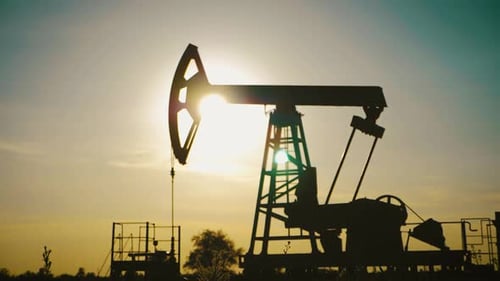Silhouette of Working Oil Pump From Oil Field at Sunset. The Industrial Equipment.