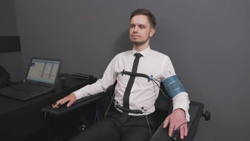 Man Undergoing Polygraph Examination in Lab