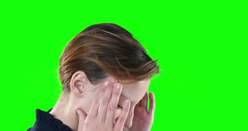 Worried Caucasian woman on green background