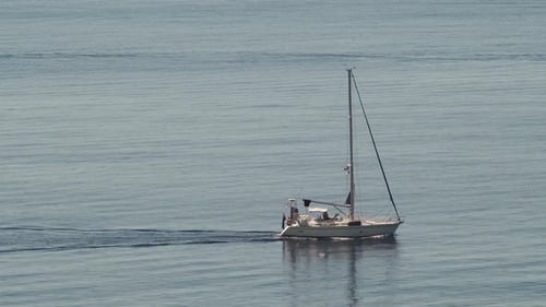 Sailboat Glides Peacefully on a Calm Ocean