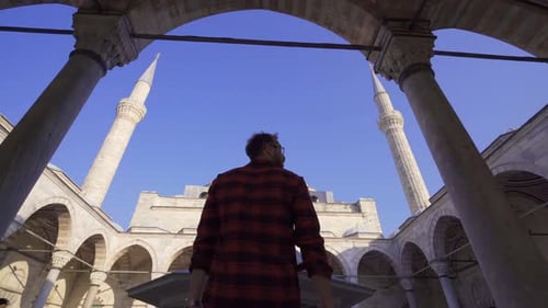 Young muslim man coming to mosque.