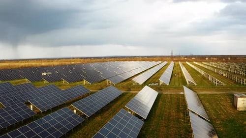 Drone fly over Solar Power Station. Top aerial view of Solar Panels. Flying from above Solar Farm.