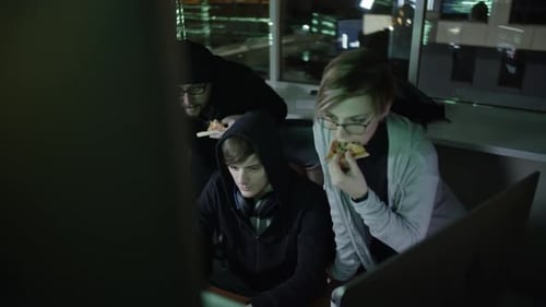 Young Adults Working Late at Night in Bright Office