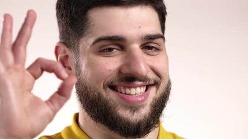 Bearded Man Smiling and Making 'Ok' Hand Gesture