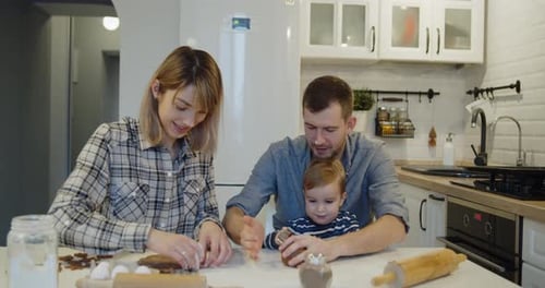 Young Full Family Having Fun Baking Cookies in the Kitchen Together