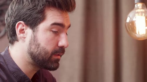 Close Up Portrait of a Handsome Young Man Having a Conversation