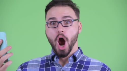 Man Reacts to Phone with Surprise and Smile