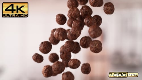 Chocolate Cereal Puffs Falling in Slow Motion Indoors