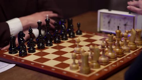 People Playing Chess Match on Wooden Table