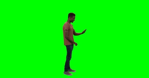 Young Adult Using Tablet on Green Screen