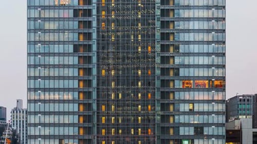 Time lapse of elevator moving and people working, office window view on business center facade